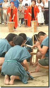 Young boys lighting the ceeremonial fire the old way