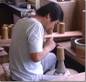 Kiln worker forming a foot Kiln worker forming a foot